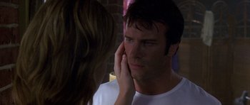 Movie still from “The Punisher” (2004), directed by Jonathan Hensleigh – A woman touching a man's face with her hand; Close Up shot, Over the shoulder angle