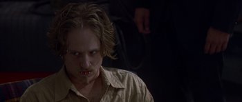 Movie still from “The Punisher” (2004), directed by Jonathan Hensleigh – A young man with long blonde hair wearing a brown shirt; Close Up shot, Low angle