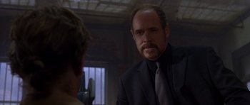 Movie still from “The Punisher” (2004), directed by Jonathan Hensleigh – A man in a suit and tie talking to another man in a suit and tie; Close Up shot, Over the shoulder angle