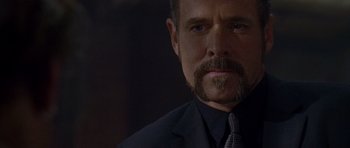 Movie still from “The Punisher” (2004), directed by Jonathan Hensleigh – A person wearing a suit and tie; Close Up shot, Over the shoulder angle