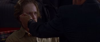 Movie still from “The Punisher” (2004), directed by Jonathan Hensleigh – A man with long blonde hair is holding a watch; Close Up shot, Over the shoulder angle