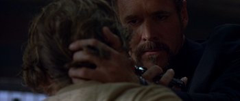 Movie still from “The Punisher” (2004), directed by Jonathan Hensleigh – A man holding a cat while looking at another man; Close Up shot, Over the shoulder angle