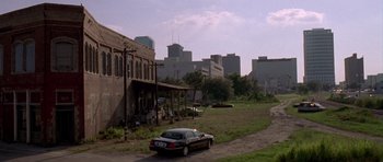 Movie still from “The Punisher” (2004), directed by Jonathan Hensleigh – An old car parked on the side of the road; Extreme Wide shot, High angle