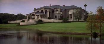 Movie still from “The Punisher” (2004), directed by Jonathan Hensleigh – A large house with a lake in front of it; Extreme Wide shot, Low angle
