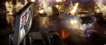 Movie still from “The Punisher” (2004), directed by Jonathan Hensleigh – Cars on a street near a fire and flames; Extreme Wide shot, Overhead angle