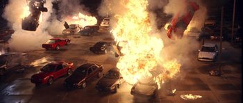 Movie still from “The Punisher” (2004), directed by Jonathan Hensleigh – Cars are on fire in an open parking lot; Extreme Wide shot, Overhead angle