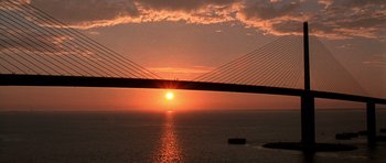 Movie still from “The Punisher” (2004), directed by Jonathan Hensleigh – The sun is setting over the ocean and a bridge; Extreme Wide shot, Low angle