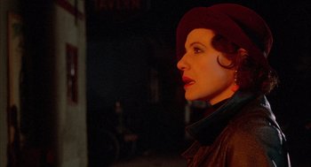 Movie still from “The Purple Rose of Cairo” (1985), directed by Woody Allen – A woman wearing a red hat looking to her left; Close Up shot, Over the shoulder angle