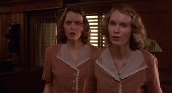 Movie still from “The Purple Rose of Cairo” (1985), directed by Woody Allen – Two women are standing side by side in front of a mirror; Close Up shot, Low angle