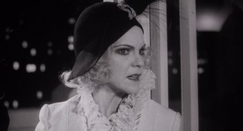 Movie still from “The Purple Rose of Cairo” (1985), directed by Woody Allen – A black and white photo of a woman wearing a hat; Close Up shot, Over the shoulder angle