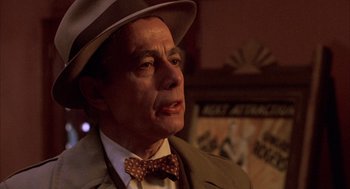 Movie still from “The Purple Rose of Cairo” (1985), directed by Woody Allen – An older man wearing a hat and a bow tie; Close Up shot, Low angle
