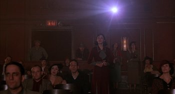 Movie still from “The Purple Rose of Cairo” (1985), directed by Woody Allen – A group of people sitting in a room; Wide shot, Low angle