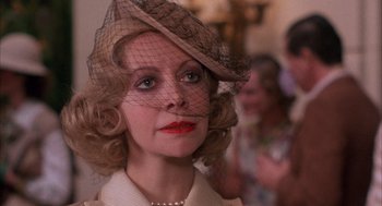 Movie still from “The Purple Rose of Cairo” (1985), directed by Woody Allen – A person wearing a hat with a veil; Close Up shot, Over the shoulder angle