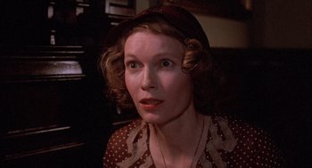 Movie still from “The Purple Rose of Cairo” (1985), directed by Woody Allen – A person wearing a hat and looking at the camera; Close Up shot, Low angle