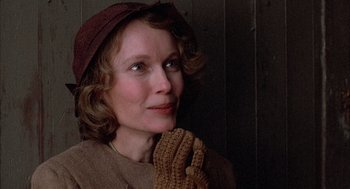 Movie still from “The Purple Rose of Cairo” (1985), directed by Woody Allen – A woman wearing a hat and holding a glove; Close Up shot, Over the shoulder angle