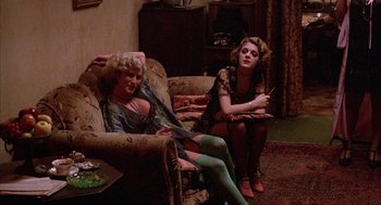 Movie still from “The Purple Rose of Cairo” (1985), directed by Woody Allen – A couple of women sitting on top of a couch; Wide shot, High angle