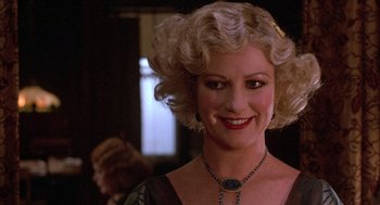 Movie still from “The Purple Rose of Cairo” (1985), directed by Woody Allen – A person wearing a necklace; Close Up shot, Over the shoulder angle