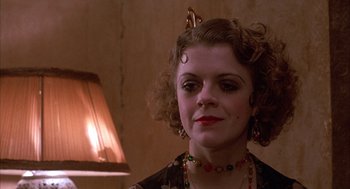 Movie still from “The Purple Rose of Cairo” (1985), directed by Woody Allen – A person wearing a necklace; Close Up shot, Low angle