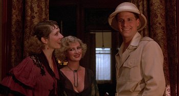 Movie still from “The Purple Rose of Cairo” (1985), directed by Woody Allen – A man standing next to a woman and another woman; Close Up shot, Over the shoulder angle