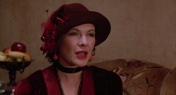 Movie still from “The Purple Rose of Cairo” (1985), directed by Woody Allen – A woman wearing a red hat and a red dress; Close Up shot, Over the shoulder angle