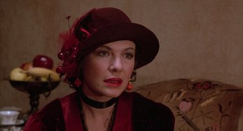Movie still from “The Purple Rose of Cairo” (1985), directed by Woody Allen – A woman wearing a red hat and a red dress; Close Up shot, Over the shoulder angle
