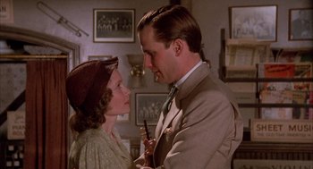 Movie still from “The Purple Rose of Cairo” (1985), directed by Woody Allen – A man and a woman standing next to each other in a room; Close Up shot, Over the shoulder angle