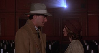 Movie still from “The Purple Rose of Cairo” (1985), directed by Woody Allen – A man and a woman are standing next to each other; Medium shot, Over the shoulder angle