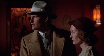 Movie still from “The Purple Rose of Cairo” (1985), directed by Woody Allen – A man and a woman wearing hats and coats; Close Up shot, Low angle