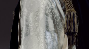 Movie still from “The Queen” (2006), directed by Stephen Frears – View of a white fabric with a floral pattern; Extreme Close Up shot, High angle