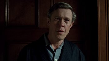 Movie still from “The Queen” (2006), directed by Stephen Frears – A person wearing a suit and tie; Close Up shot, Low angle