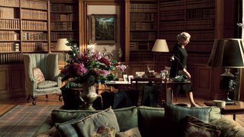Movie still from “The Queen” (2006), directed by Stephen Frears – A woman in a room with a vase filled with flowers; Wide shot, High angle