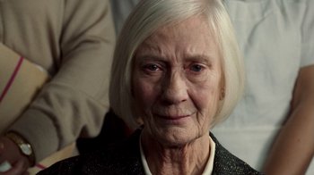 Movie still from “The Queen” (2006), directed by Stephen Frears – An older woman with white hair looking at the camera; Close Up shot, Over the shoulder angle
