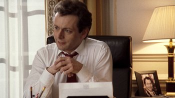 Movie still from “The Queen” (2006), directed by Stephen Frears – A man sitting in front of a desk in a room; Close Up shot, Over the shoulder angle