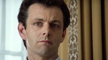 Movie still from “The Queen” (2006), directed by Stephen Frears – A person wearing a white shirt; Close Up shot, Low angle