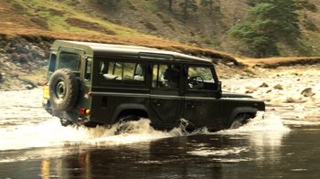 Movie still from “The Queen” (2006), directed by Stephen Frears – A jeep driving through a body of water; Wide shot, High angle