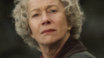 Movie still from “The Queen” (2006), directed by Stephen Frears – An older woman with grey curly hair looking at the camera; Close Up shot, Low angle