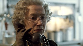 Movie still from “The Queen” (2006), directed by Stephen Frears – An older woman talking on a phone while wearing glasses; Close Up shot, Low angle