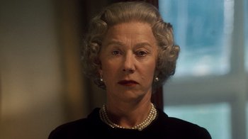 Movie still from “The Queen” (2006), directed by Stephen Frears – An older woman wearing a black dress and pearls; Close Up shot, Low angle