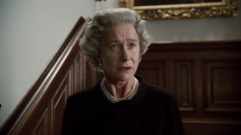Movie still from “The Queen” (2006), directed by Stephen Frears – An older woman wearing a black jacket and pearls; Close Up shot, Low angle