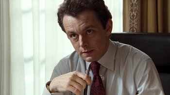Movie still from “The Queen” (2006), directed by Stephen Frears – A person wearing a shirt and a tie; Close Up shot, High angle