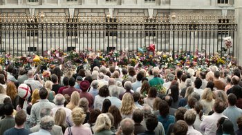 Movie still from “The Queen” (2006), directed by Stephen Frears – A crowd of people gathered in front of a building; Wide shot, High angle