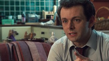 Movie still from “The Queen” (2006), directed by Stephen Frears – A person sitting on a couch; Close Up shot, Over the shoulder angle