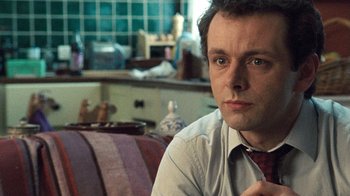 Movie still from “The Queen” (2006), directed by Stephen Frears – A person sitting in a room; Close Up shot, Over the shoulder angle