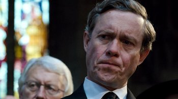 Movie still from “The Queen” (2006), directed by Stephen Frears – A person wearing a suit and tie; Close Up shot, Low angle