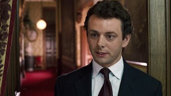 Movie still from “The Queen” (2006), directed by Stephen Frears – A person wearing a suit and tie; Close Up shot, High angle