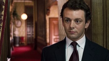Movie still from “The Queen” (2006), directed by Stephen Frears – A person wearing a suit and tie; Close Up shot, Low angle