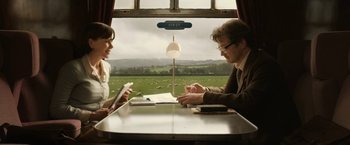 Movie still from “The Railway Man” (2013), directed by Jonathan Teplitzky – A man and a woman sitting in front of a window; Medium shot, High angle