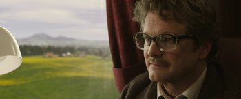 Movie still from “The Railway Man” (2013), directed by Jonathan Teplitzky – A man with glasses sitting in front of a window; Close Up shot, Low angle