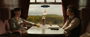 Movie still from “The Railway Man” (2013), directed by Jonathan Teplitzky – Two people are sitting at a table in front of a window; Wide shot, High angle