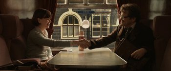 Movie still from “The Railway Man” (2013), directed by Jonathan Teplitzky – Two people shaking hands over a table in a restaurant; Medium shot, High angle